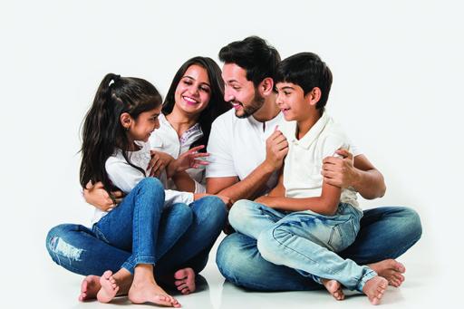Family sitting on the floor on white background.