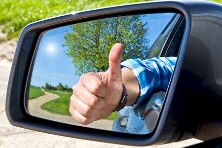 Thumbs up in a car side mirror