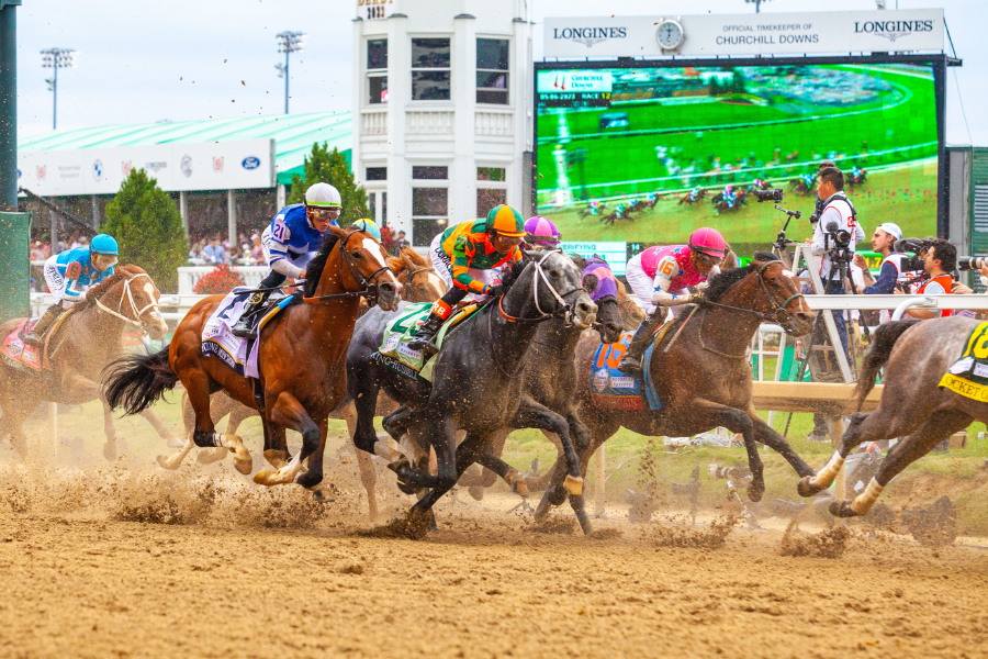 Horses racing on the Churchill Downs track